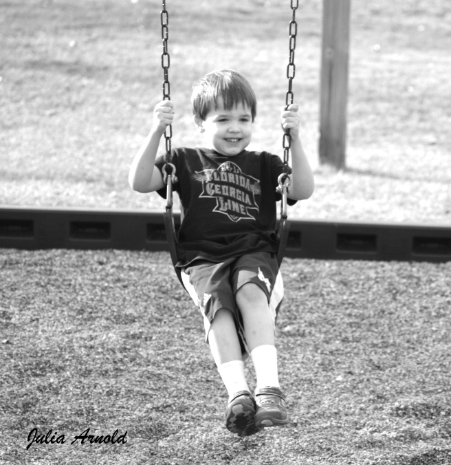 John on Swing in Black and White with Logo